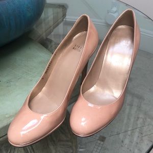 Stuart Weitzman Nude patent leather pumps.